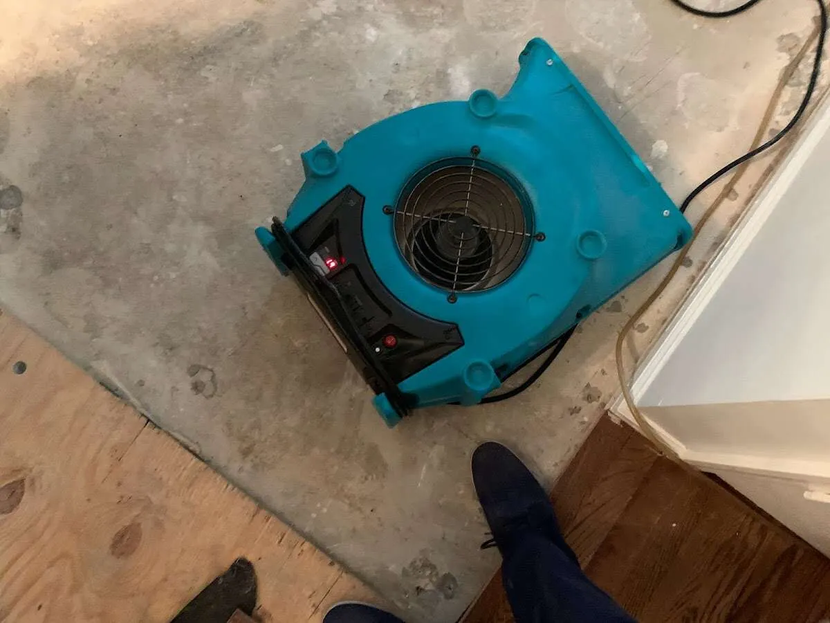 Air mover drying subfloor during Commercial Water Damage Restoration in Reading